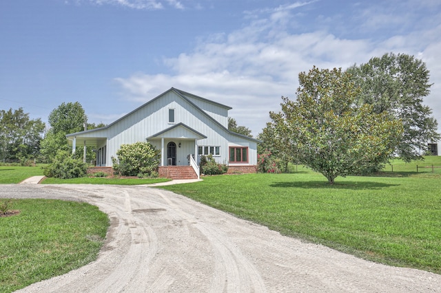 modern farmhouse with a front lawn and covered porch