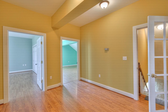 corridor with light hardwood / wood-style floors