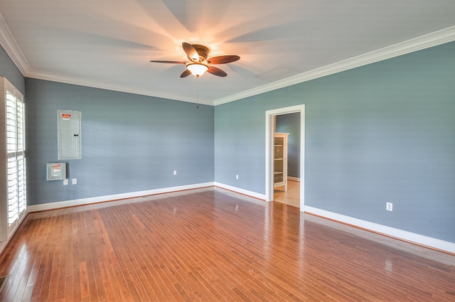 unfurnished room with hardwood / wood-style floors, ornamental molding, ceiling fan, and electric panel