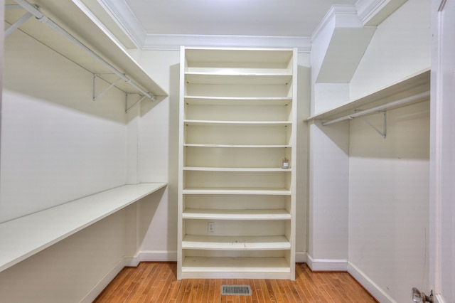 spacious closet with light hardwood / wood-style flooring