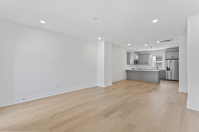 unfurnished living room with light wood-type flooring