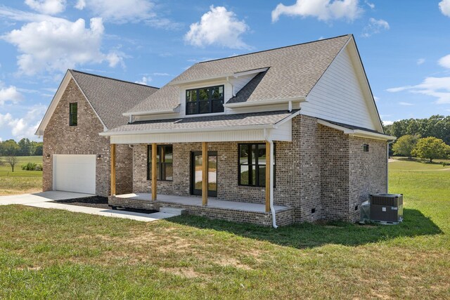 view of front of home featuring a garage, central AC unit, a porch, and a front yard