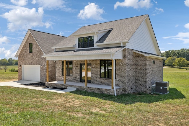 view of front of property featuring driveway, brick siding, central AC unit, covered porch, and a front yard