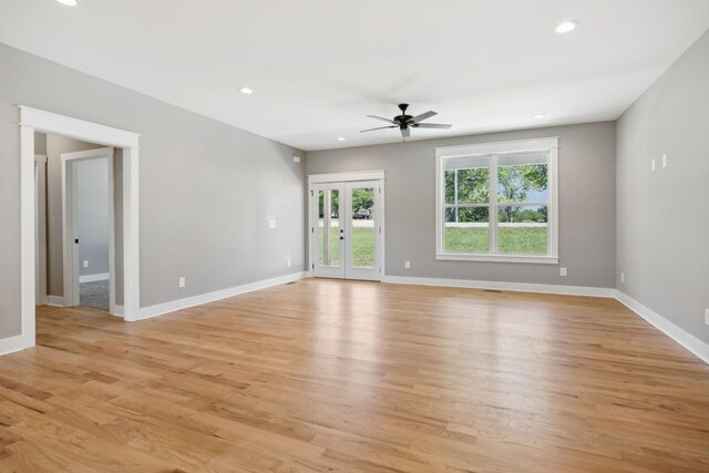 spare room with ceiling fan, french doors, and light hardwood / wood-style floors