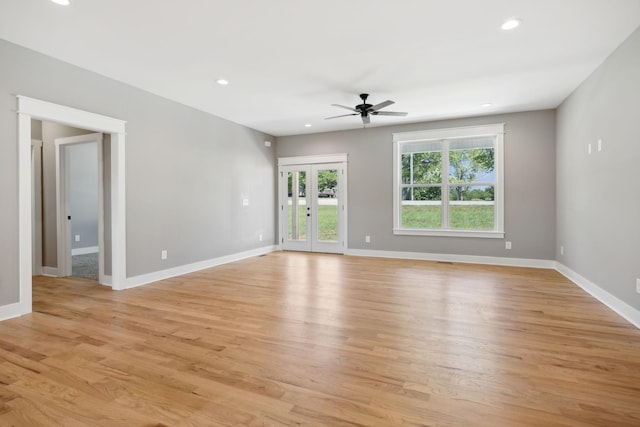 unfurnished room featuring recessed lighting, a ceiling fan, light wood-style floors, baseboards, and french doors