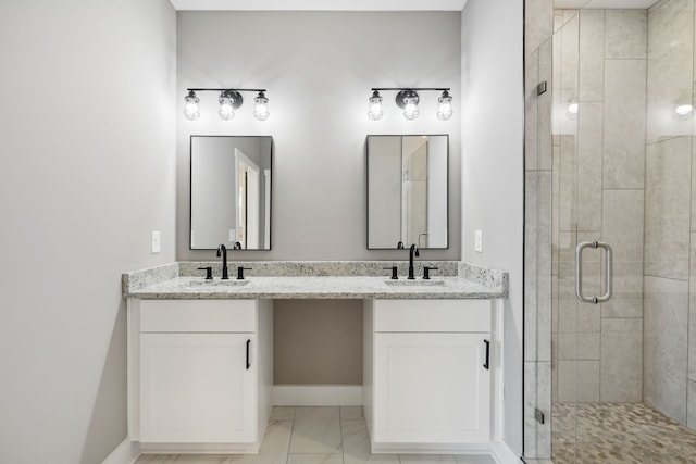 bathroom featuring a shower with door and vanity