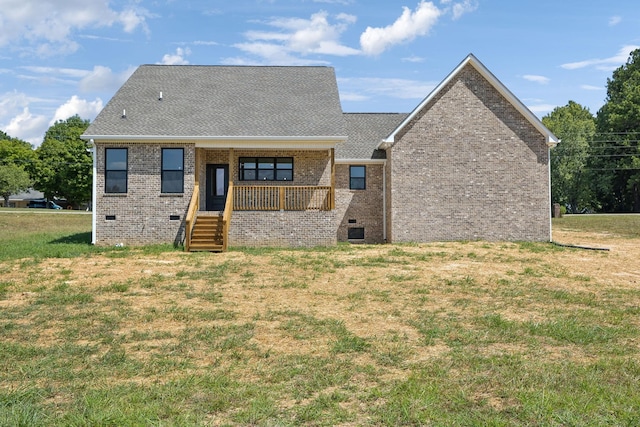 view of front facade featuring covered porch, brick siding, crawl space, and a front yard