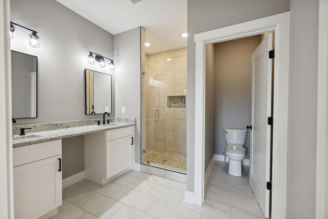 bathroom featuring vanity, an enclosed shower, and toilet