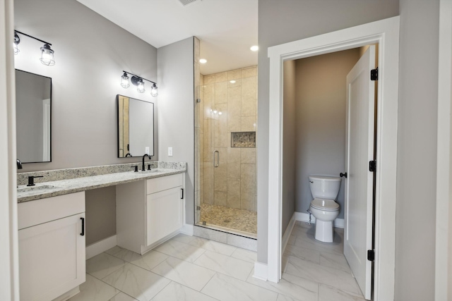 bathroom with marble finish floor, a stall shower, a sink, and toilet