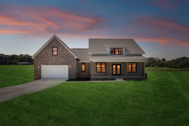 view of front of home featuring driveway, a garage, covered porch, a front lawn, and brick siding