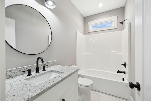 bathroom featuring vanity, toilet, and bathing tub / shower combination