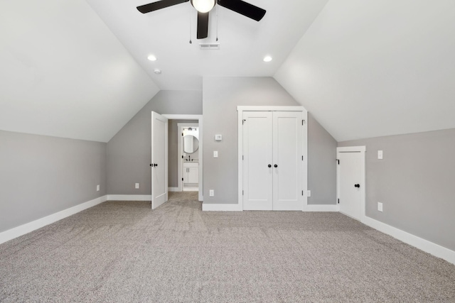 bonus room with baseboards, visible vents, and light colored carpet