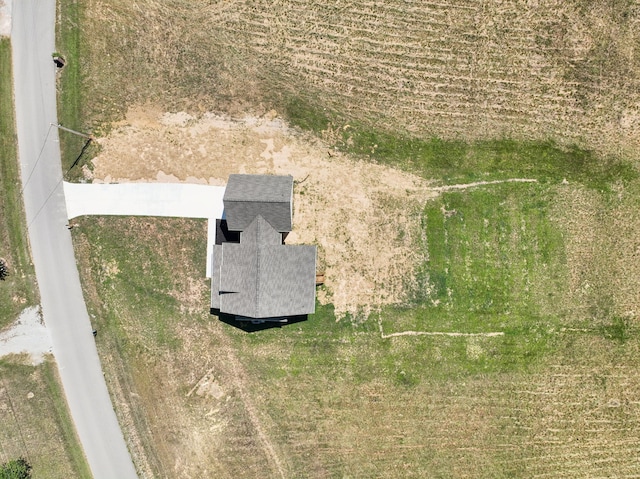 birds eye view of property with a rural view