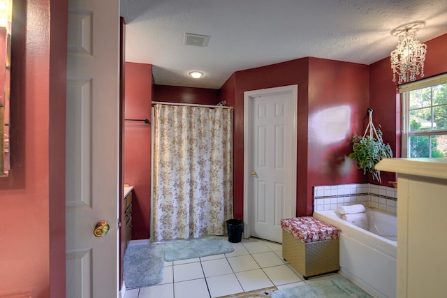 bathroom featuring a textured ceiling, vanity, a notable chandelier, tile patterned flooring, and independent shower and bath