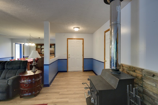 interior space with a textured ceiling and light hardwood / wood-style flooring