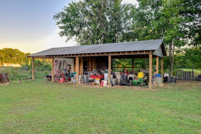 outdoor structure at dusk featuring a lawn