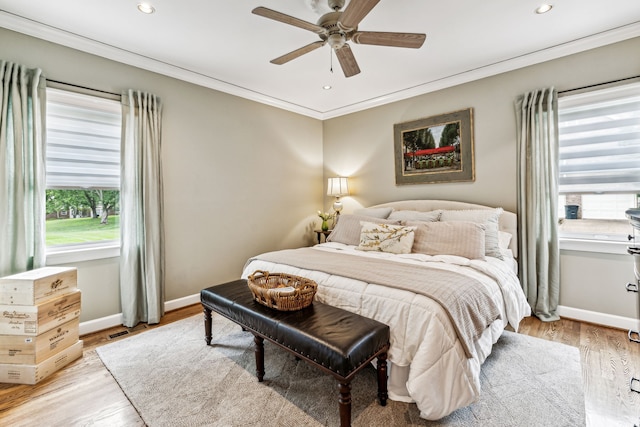 bedroom featuring ceiling fan, light hardwood / wood-style floors, and ornamental molding