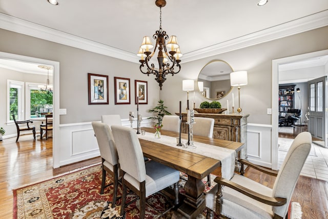 dining area featuring hardwood / wood-style flooring, a wealth of natural light, and a notable chandelier