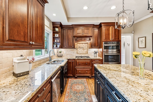 kitchen with light wood-type flooring, an inviting chandelier, sink, hanging light fixtures, and appliances with stainless steel finishes