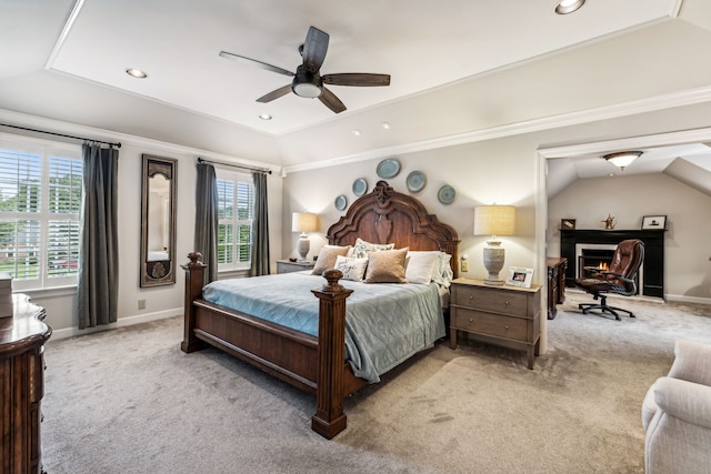 bedroom with lofted ceiling, multiple windows, ceiling fan, and light carpet