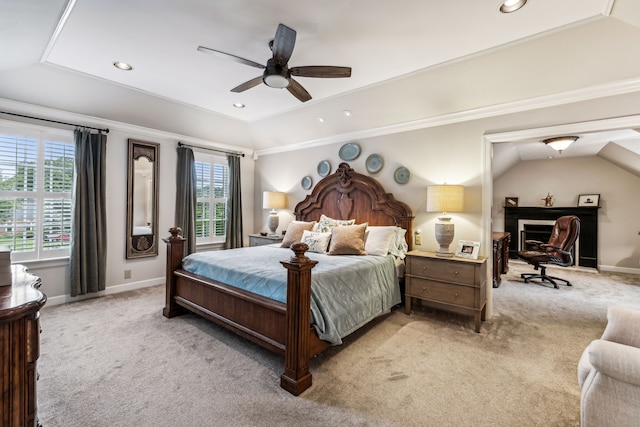 bedroom featuring multiple windows, light colored carpet, vaulted ceiling, and ceiling fan