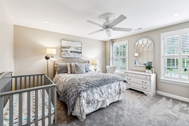 bedroom with multiple windows, ceiling fan, and carpet flooring