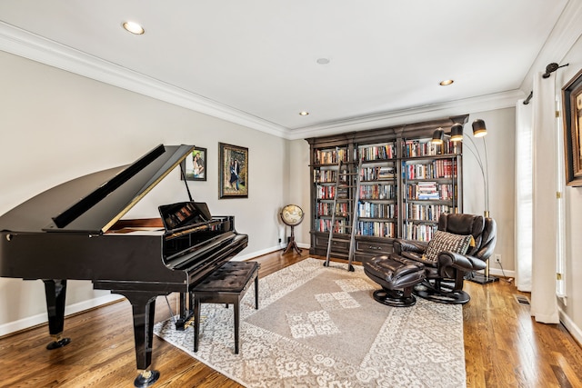 living area featuring crown molding and wood-type flooring