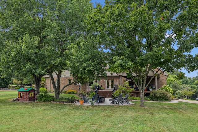 back of house featuring a patio area and a lawn