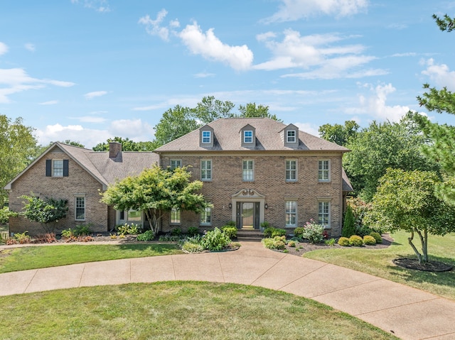 colonial inspired home with a front yard