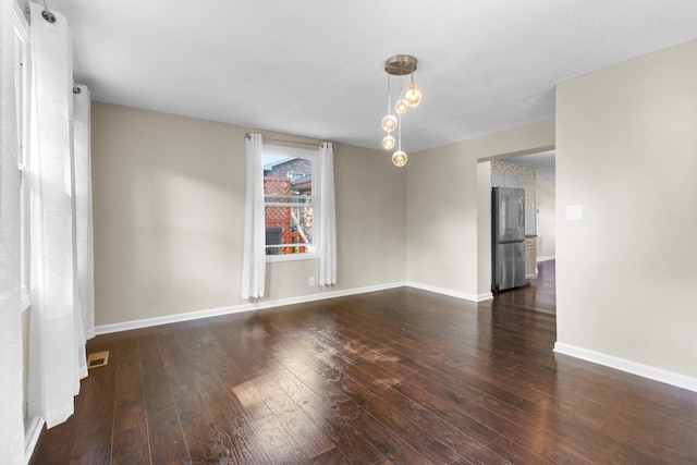 spare room featuring wood-type flooring