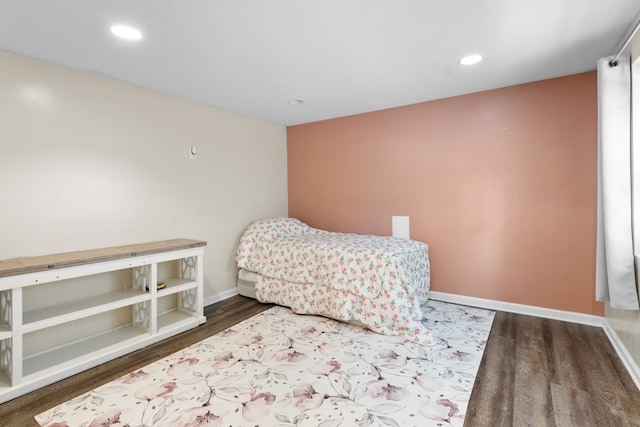 bedroom with dark hardwood / wood-style flooring