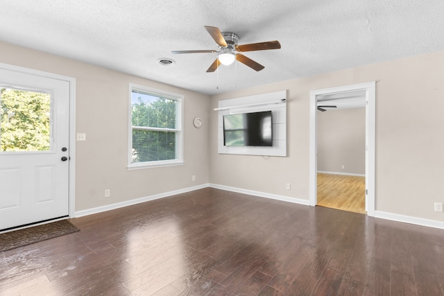 interior space featuring a textured ceiling, plenty of natural light, ceiling fan, and wood-type flooring