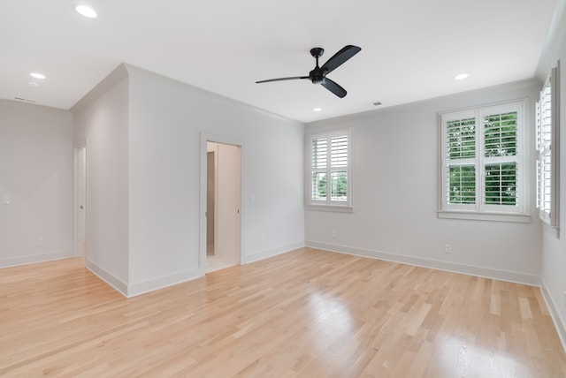 spare room with light wood-type flooring, ceiling fan, and ornamental molding