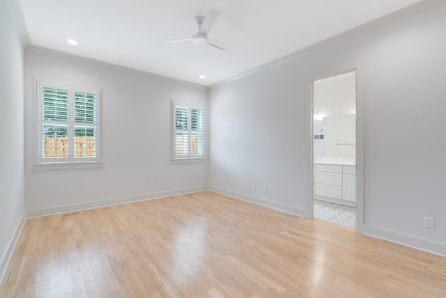 spare room with light hardwood / wood-style flooring, ceiling fan, and crown molding