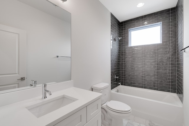 full bathroom featuring toilet, vanity, and tiled shower / bath