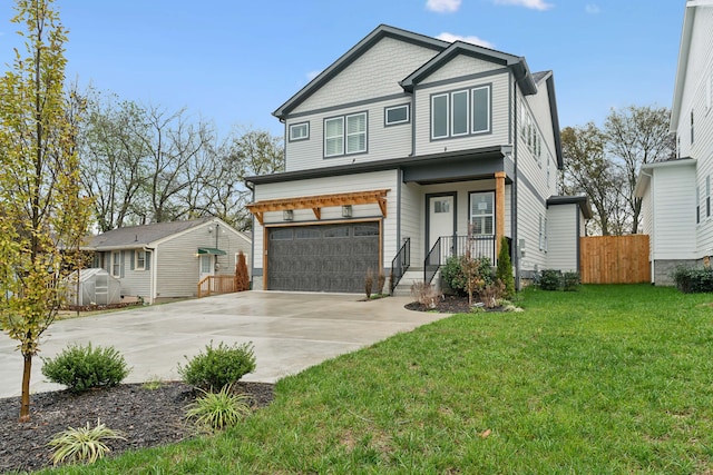 view of front of home featuring a garage and a front yard