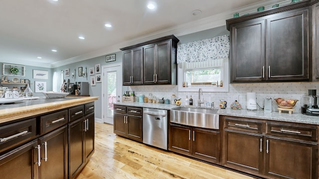 kitchen with sink, dark brown cabinetry, decorative backsplash, light hardwood / wood-style floors, and stainless steel dishwasher