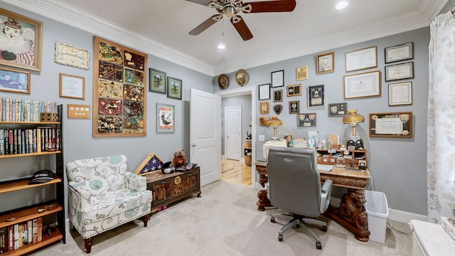 office space with ceiling fan, ornamental molding, and light colored carpet