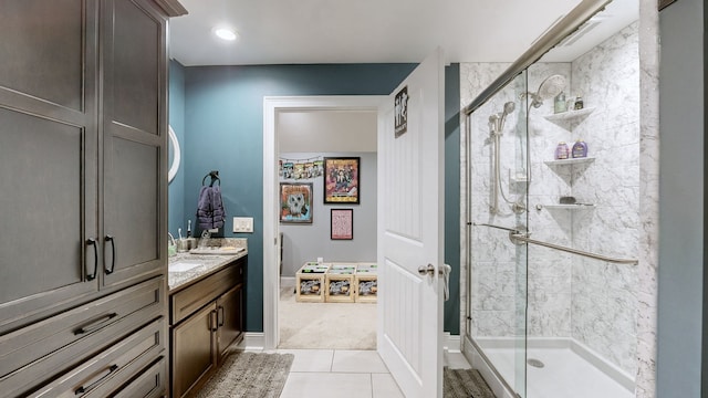 bathroom with tile patterned flooring, vanity, and walk in shower