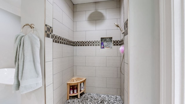 bathroom with a tile shower