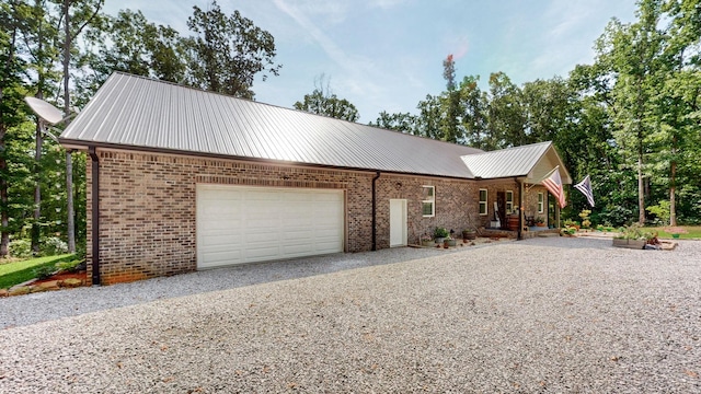1019 Parker Rd, Kingston Springs, TN 37082 - ranch-style house with gravel driveway, brick siding, a garage, and metal roof