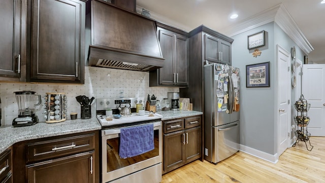 kitchen featuring light hardwood / wood-style flooring, premium range hood, stainless steel refrigerator, range with electric stovetop, and dark brown cabinets