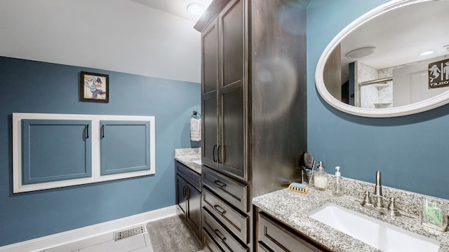 bathroom with tile patterned flooring and vanity