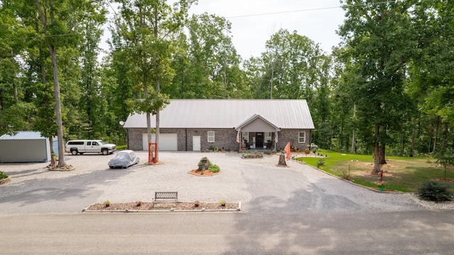 1019 Parker Rd, Kingston Springs, TN 37082 - view of front of property featuring stone siding, metal roof, and a garage