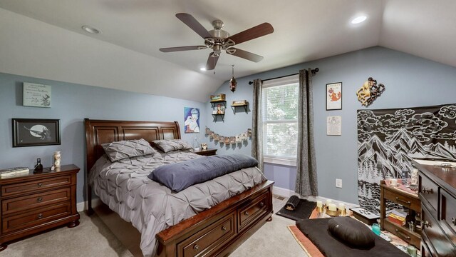 carpeted bedroom with ceiling fan and vaulted ceiling