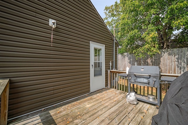 wooden terrace featuring a grill