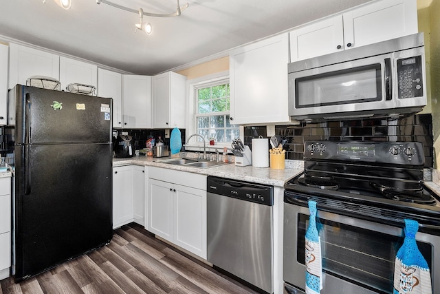 kitchen featuring appliances with stainless steel finishes, decorative backsplash, white cabinetry, dark hardwood / wood-style floors, and sink