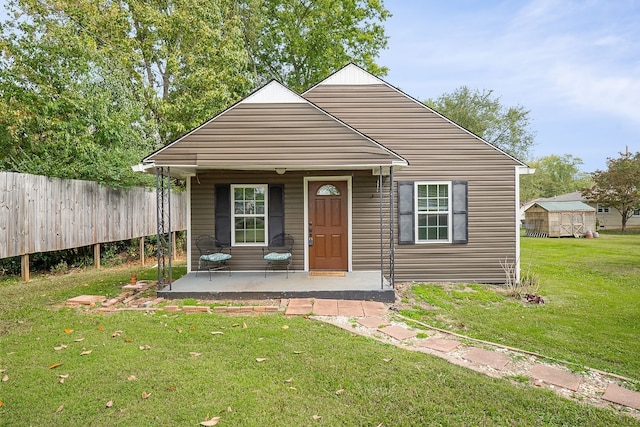 bungalow-style home with an outdoor structure and a front yard