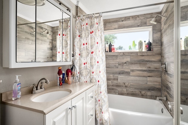 bathroom featuring ornamental molding, vanity, and shower / tub combo