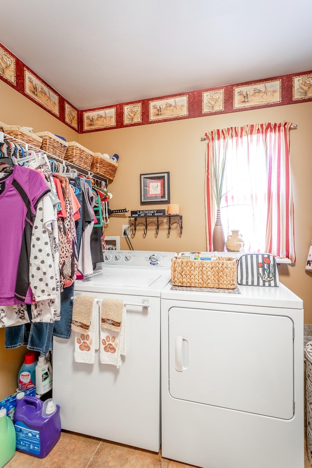 laundry room featuring light tile patterned flooring and washing machine and clothes dryer